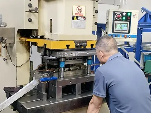 An Male Operating A Stamping Machine