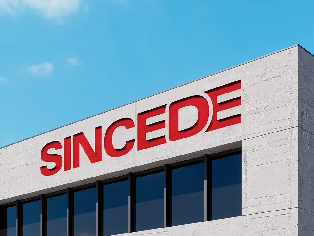 An image of a corner of the Sincede factory, with the "Sincede" logo displayed on the wall.
