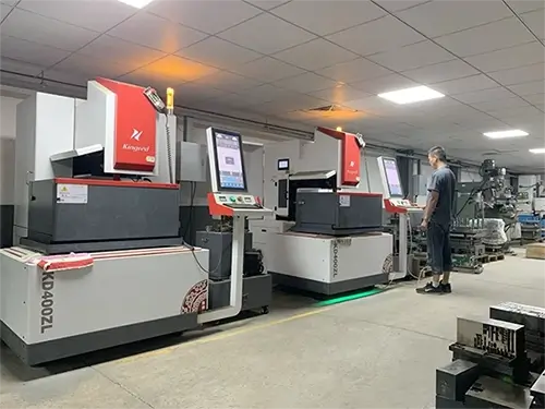 A technician Operating An Advanced Wire Cut EDM Machine