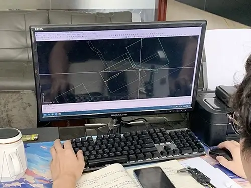 An engineer designing a mold using a computer.