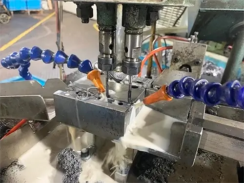 A close-up image of the tapping head of an automatic tapping machine.