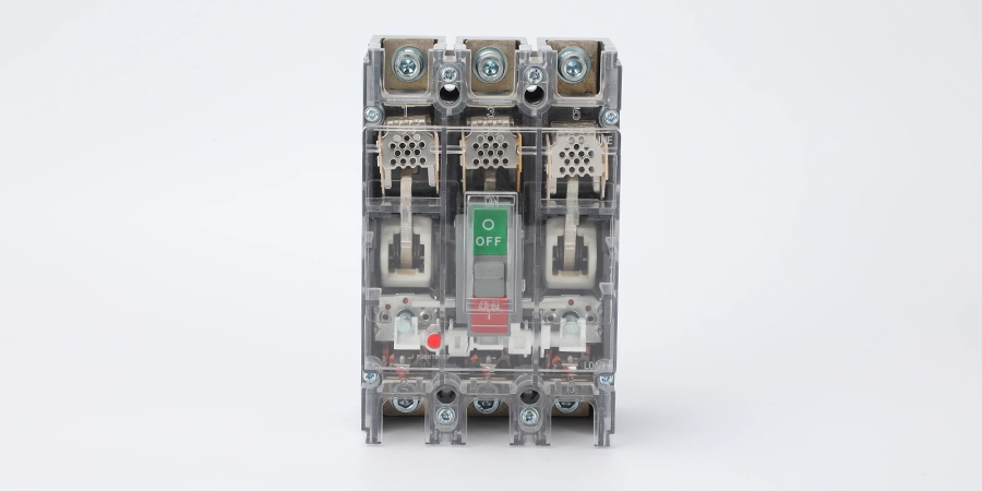 A transparent mccb with a green 'ON' button, a red 'OFF' button, and visible internal components, against a white background.