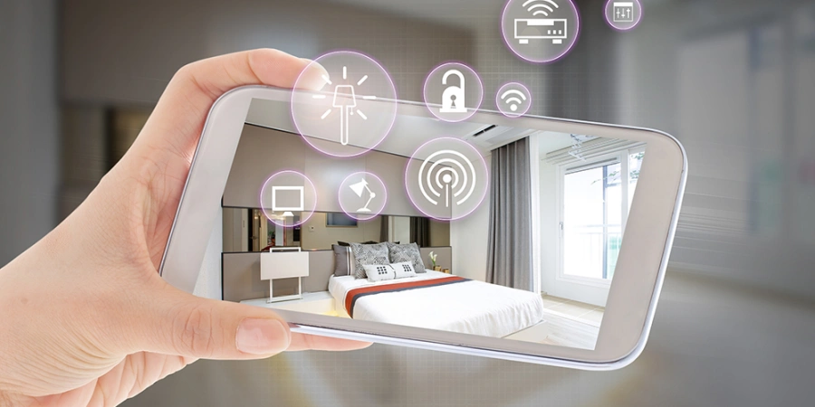 Hand holding a smartphone displaying a smart bedroom with holographic icons for lighting, security, Wi-Fi, and temperature control