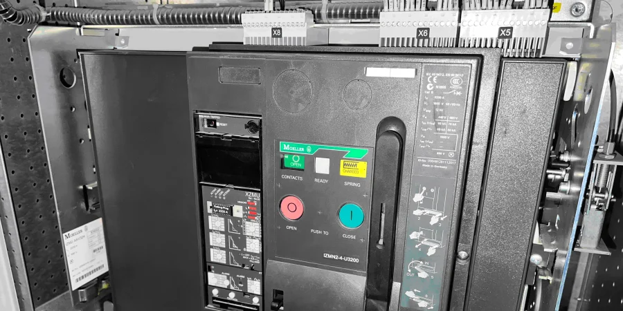 A black air circuit breaker (ACB) labeled with the Moeller brand, featuring a green