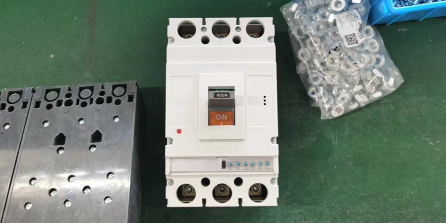 A white electronic molded case circuit breaker (MCCB) with an orange 