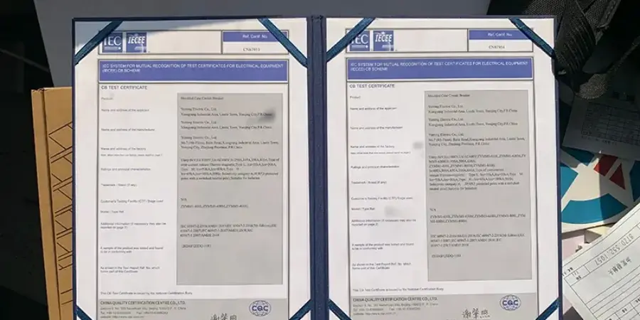 A photograph of two framed IECEE CB Scheme test certificates issued to Sincede molded case circuit breakers. These certificates are part of the CB Scheme for mutual recognition of electrical equipment test results. The documents, numbered CN3913 and CN3914, detail testing of Sincede’s molded case circuit breakers, referencing standards such as IEC 60947-2, with test reports and certification issued by CQC (China Quality Certification Centre). These certificates enable international recognition of test results across member countries, facilitating global market access and compliance for Sincede low-voltage circuit breakers in the Asia Pacific region.