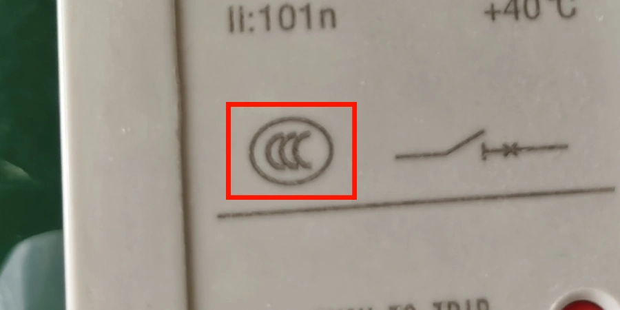 A close-up view shows the 'CCC' certification logo printed on the casing of a molded case circuit breaker (MCCB). The mark is centered within a red square for emphasis.