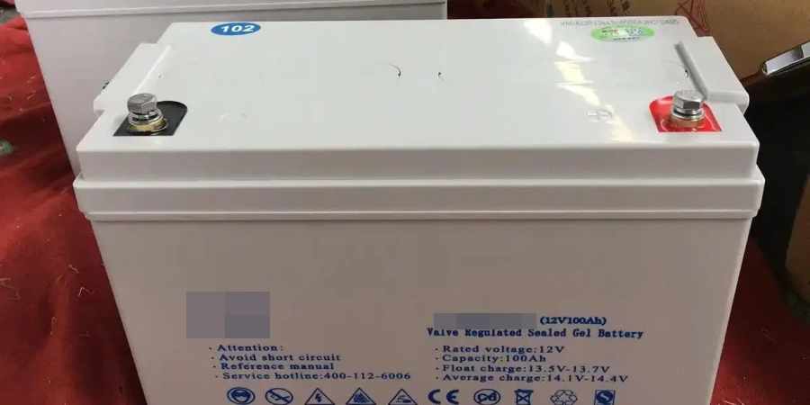 White 12V 100Ah valve-regulated sealed gel battery designed for solar systems, shown upright on a red floor. Top features two screw terminals with red and black covers, blue '102' label, vent cap, and printed specs including rated voltage 12V, capacity 100Ah, float charge 13.5V-13.7V, average charge 13.1V-14.4V, safety warnings, and CE/RoHS symbols.