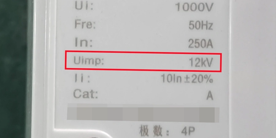 Close-up of an electrical MCCB specification label with a red rectangle highlighting Uimp 12kV, showing other ratings including Ui 1000V, Fre 50Hz, In 250A, and 4P at the bottom